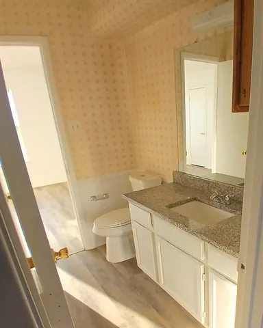 a kitchen with wooden floors and a sink