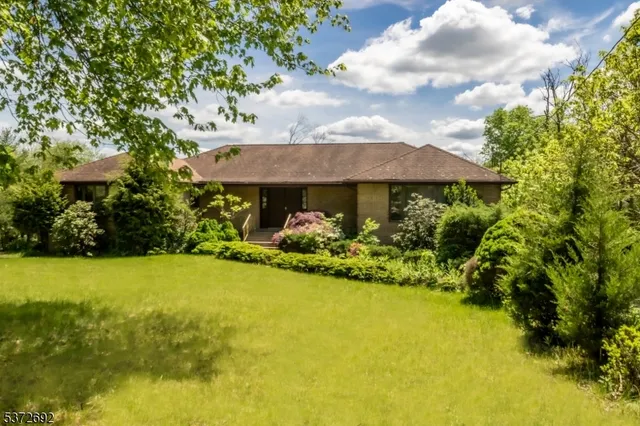 a view of a house with a yard and garage