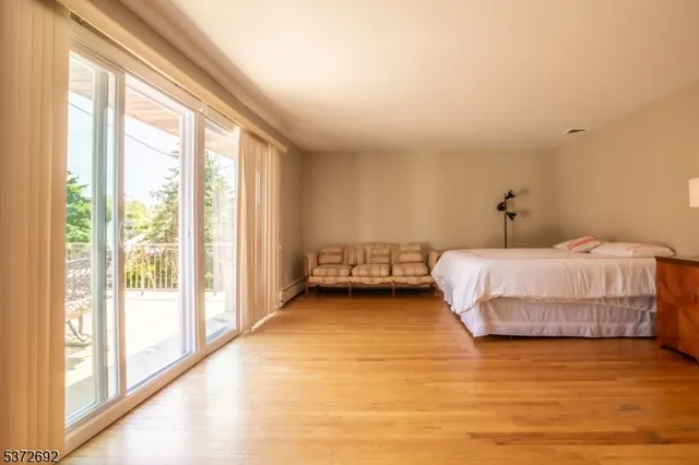 a bedroom with a bed and a large window
