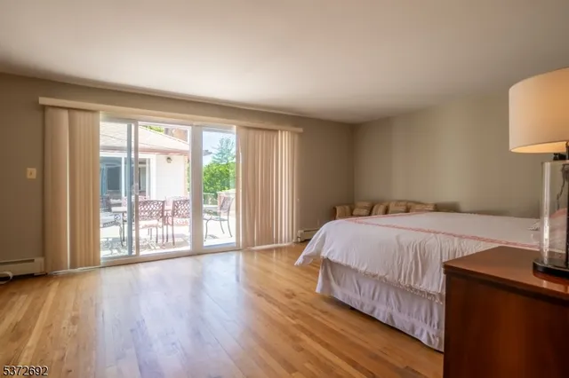 a bedroom with a bed and a lamp next to a window