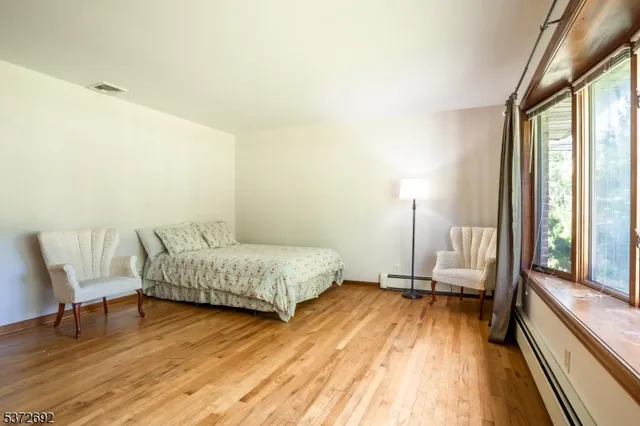 a living room with a bed furniture and a large window