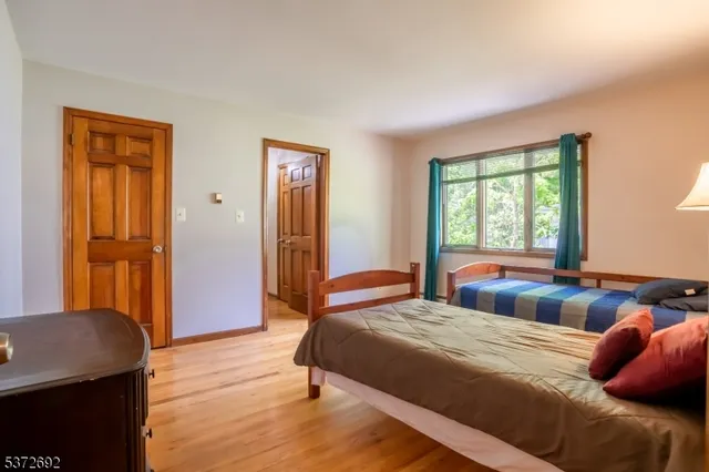 a bedroom with a large bed and a window