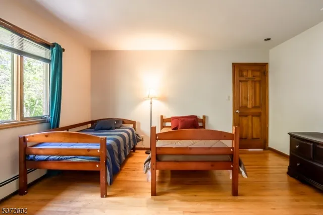 a bedroom with a bed and a tv on table