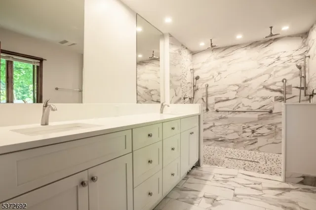 a bathroom with double vanity sink and a mirror