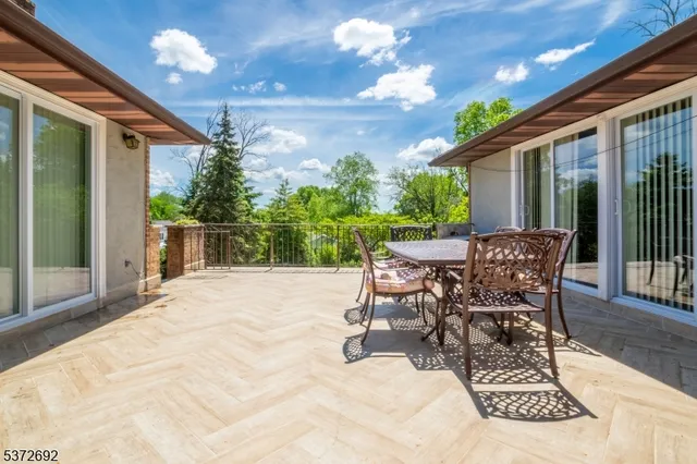 a view of a patio with table and chairs and potted plants
