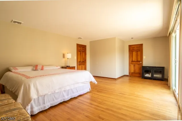 a spacious bedroom with a bed and a view of bedroom