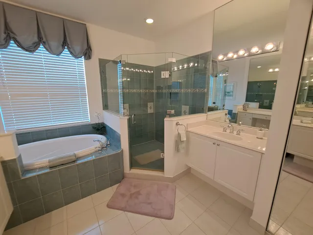 a bathroom with a sink a toilet a mirror and bathtub