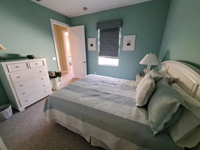 a bedroom with a bed and a baby crib