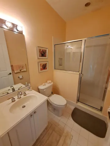 a bathroom with a sink and mirror with toilet