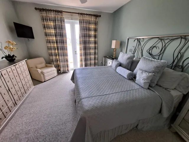 a bedroom with a bed and flat screen tv