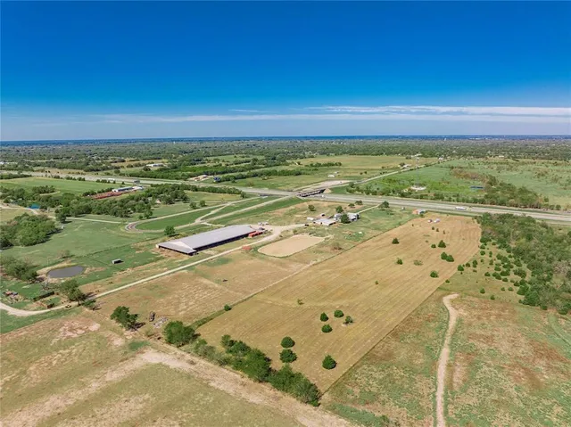 an aerial view of a house with a yard