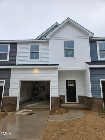 a front view of a house with garage
