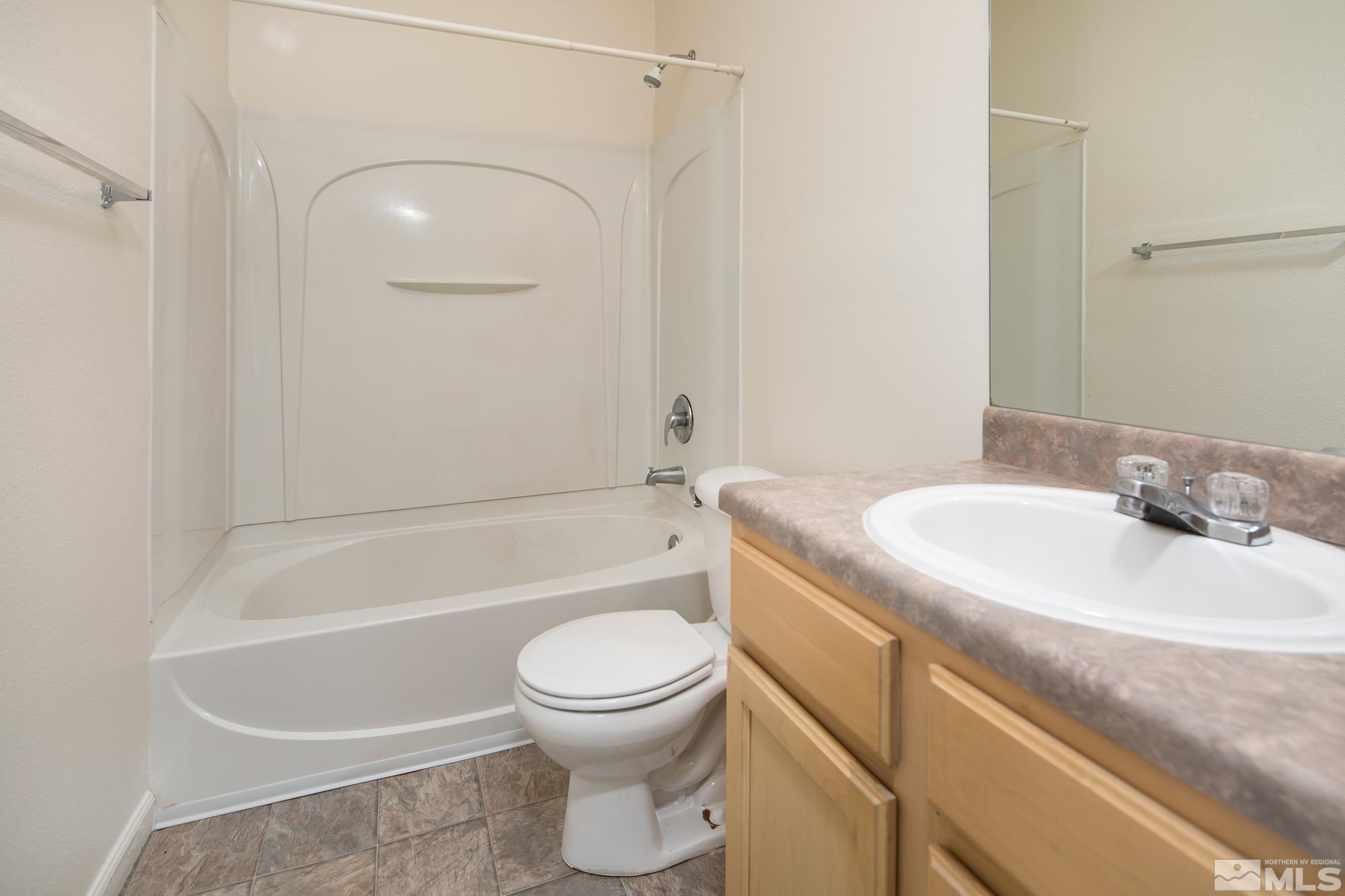 200 Talus Way, Unit 414 Reno, NV 89503 - Photo 12 of 22 a bathroom with a sink a toilet and a bathtub