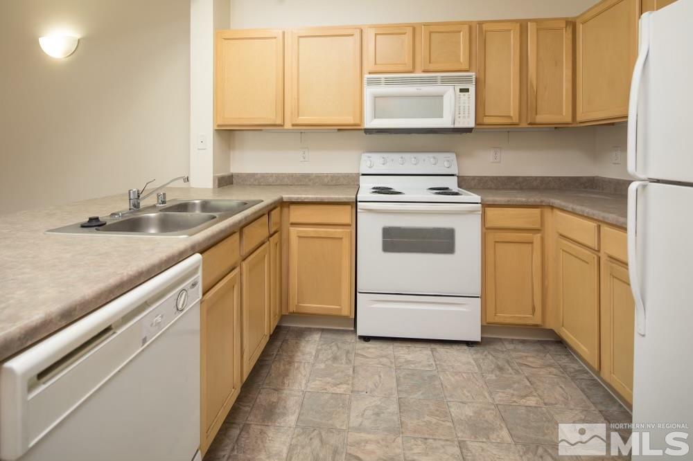 200 Talus Way, Unit 414 Reno, NV 89503 - Photo 7 of 22 a kitchen with granite countertop white cabinets and white appliances