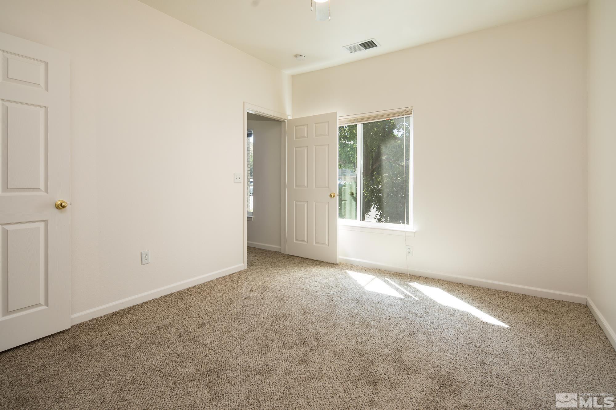 200 Talus Way, Unit 414 Reno, NV 89503 - Photo 10 of 22 an empty room with windows and closet