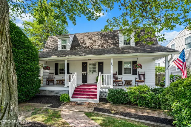 a front view of house with yard outdoor seating and green space