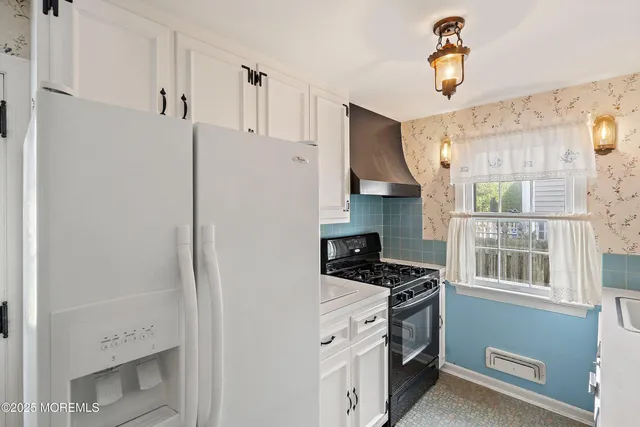 a kitchen with a refrigerator and a stove
