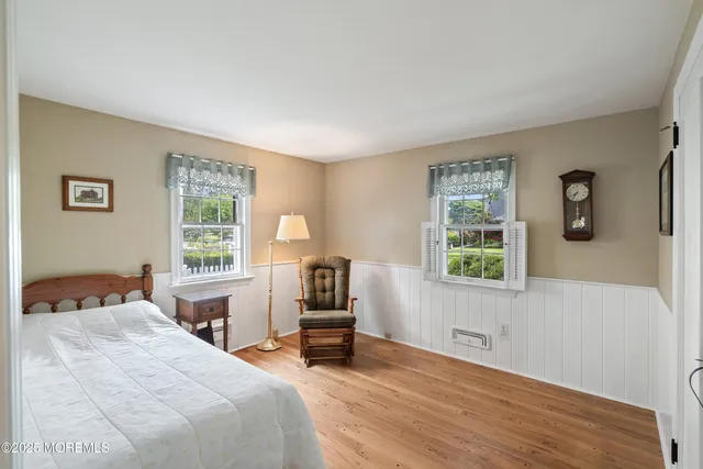 a bedroom with a bed a table and a window