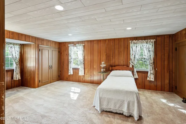 a spacious bedroom with a large bed and a large window