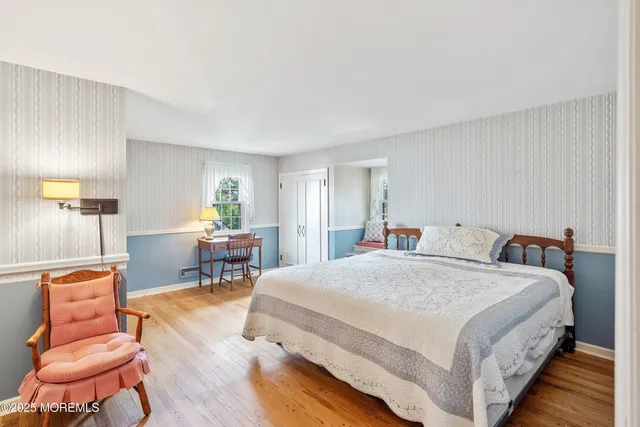 a bed room with a bed and a chair