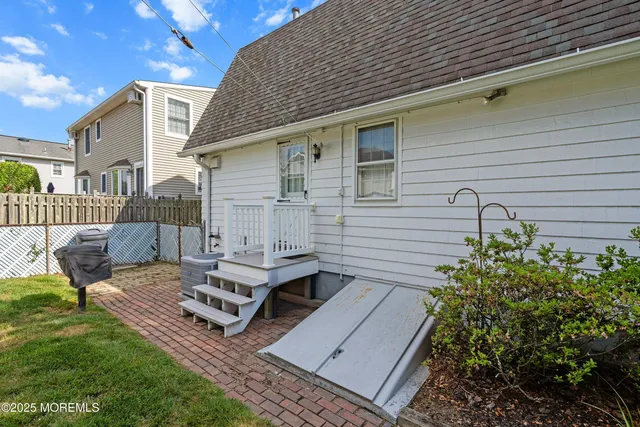 a view of a house with a yard and sitting area