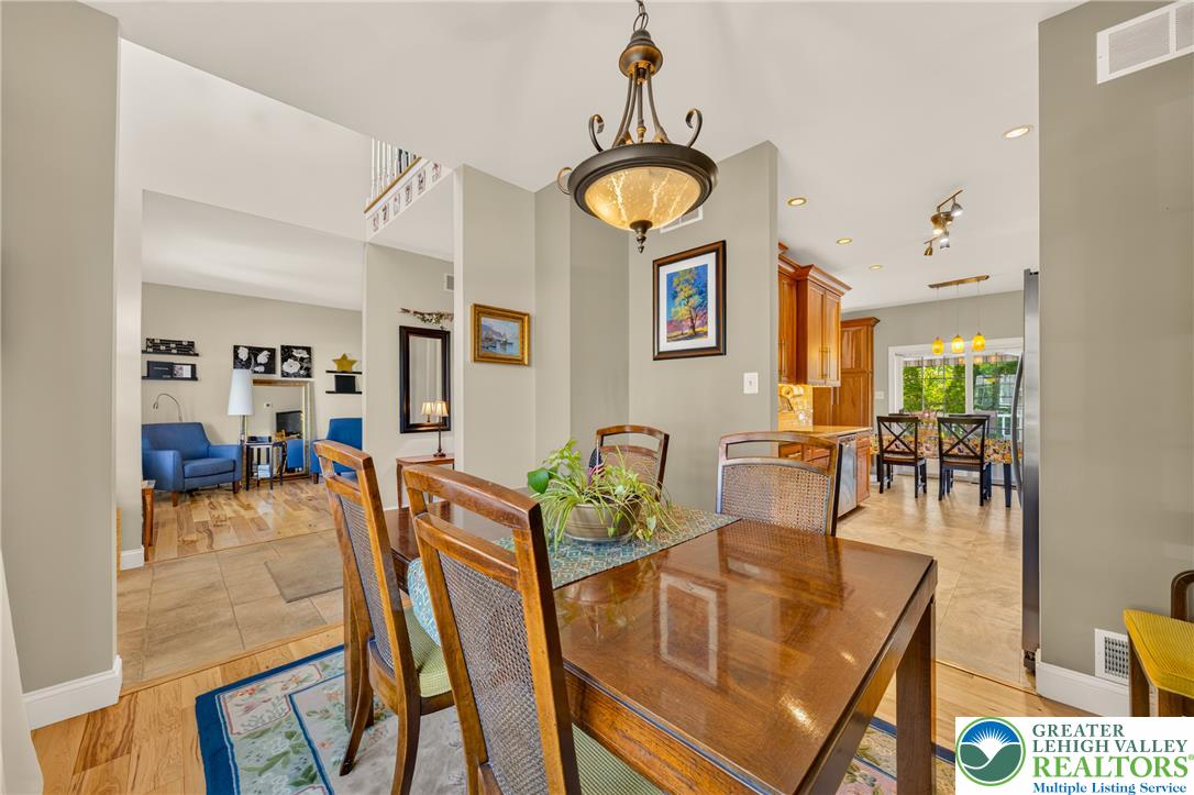 1702 Red Bud Road Quakertown, PA 18951 - Photo 11 of 68 An elegant chandelier illuminates the dining area, seamlessly connecting to the living space.