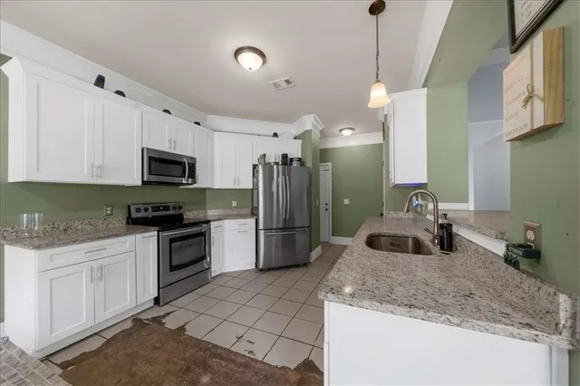 a kitchen with a sink a stove a microwave and refrigerator