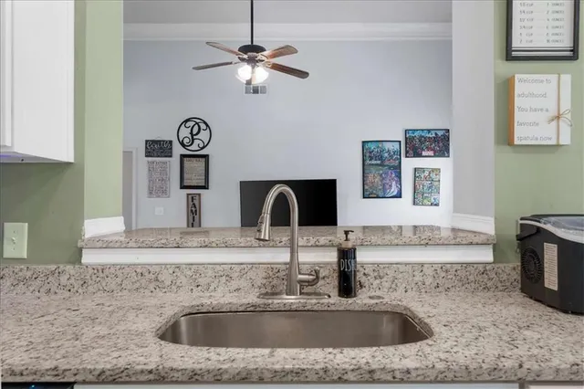 a kitchen with a sink and a stove top oven