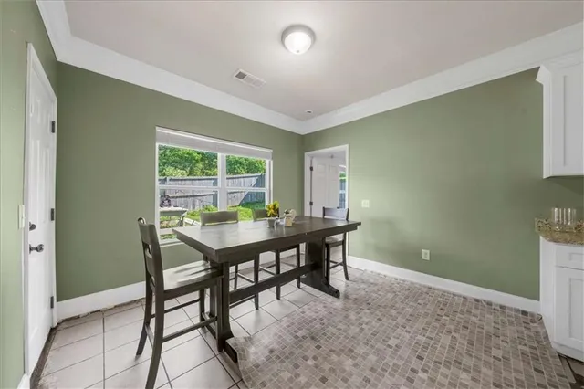 a view of a room that has a table and chairs in it