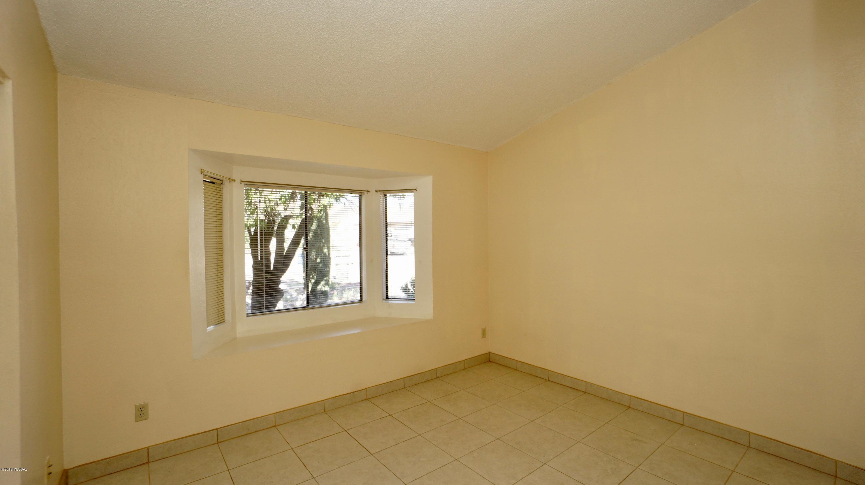 4796 South Lincoln Ridge Drive Tucson, AZ 85730 - Photo 8 of 12 a view of an empty room with a window