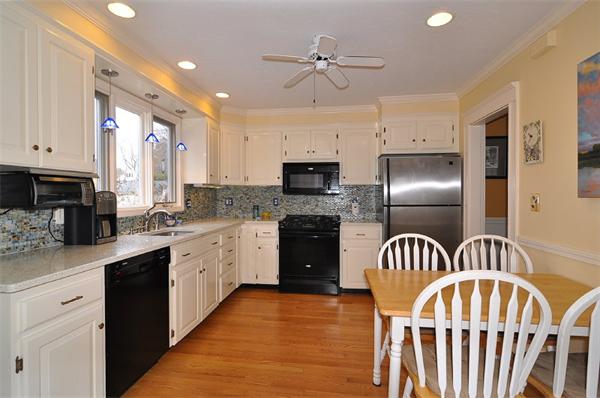 24 Cavanagh Road Wellesley, MA 02481 - Photo 3 of 17 a kitchen with stainless steel appliances kitchen island granite countertop a refrigerator a sink dishwasher a stove and white cabinets