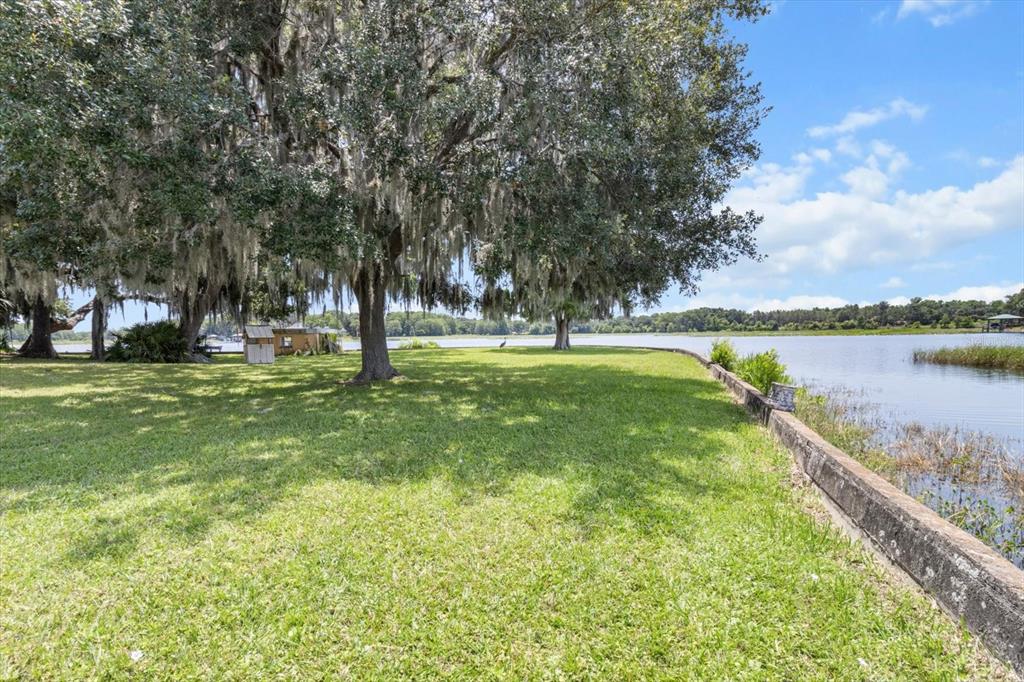 1226 South Telephone Point Road Inverness, FL 34450 - Photo 12 of 43 a swimming pool with outdoor seating and yard