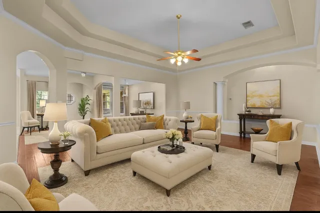 a living room with furniture and a chandelier