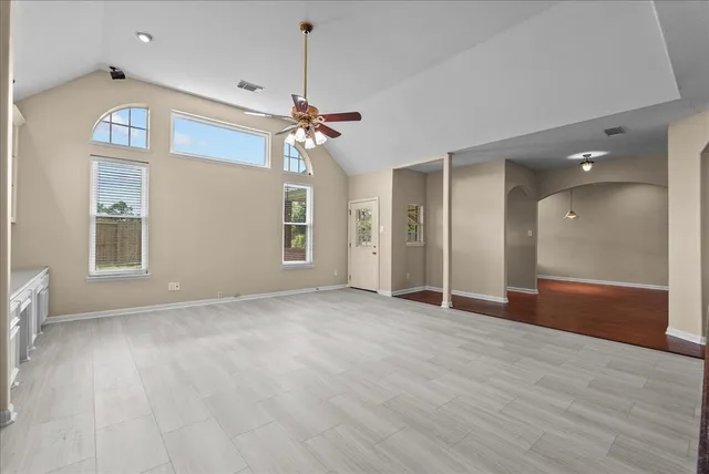a living room with stainless steel appliances kitchen island furniture and a kitchen view
