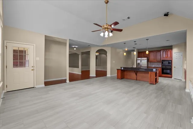 a living room with furniture and kitchen view