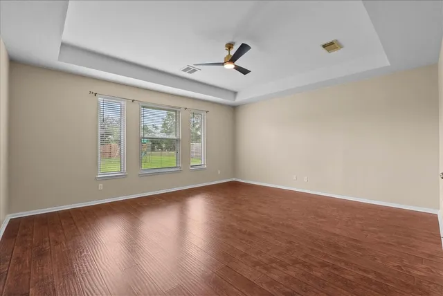 a spacious bathroom with a tub sink and mirror