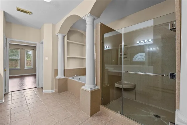 an empty room with wooden floor a ceiling fan and closet area