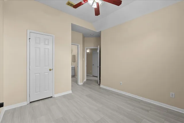 a view of a room with window and ceiling fan