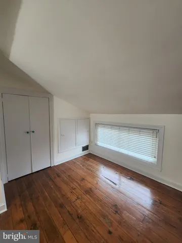 a view of an empty room and wooden floor