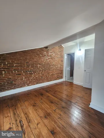 a view of an empty room and wooden floor