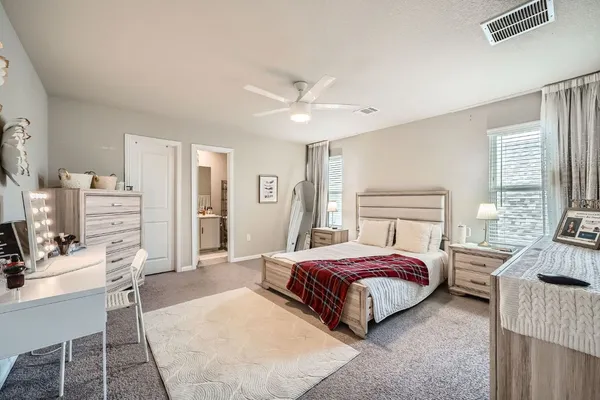 a bedroom with a bed couch and a window