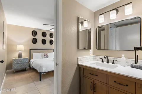 a bedroom with a bed window and couch