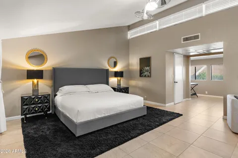 a bathroom with a granite countertop sink a toilet and a mirror