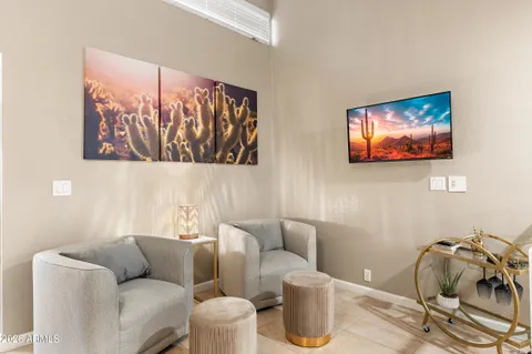 a view of a workspace with furniture and a window