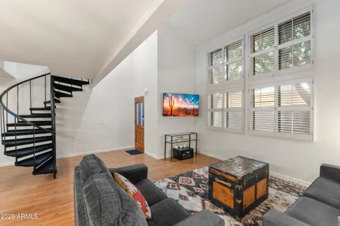 a bed sitting in a bedroom next to a window