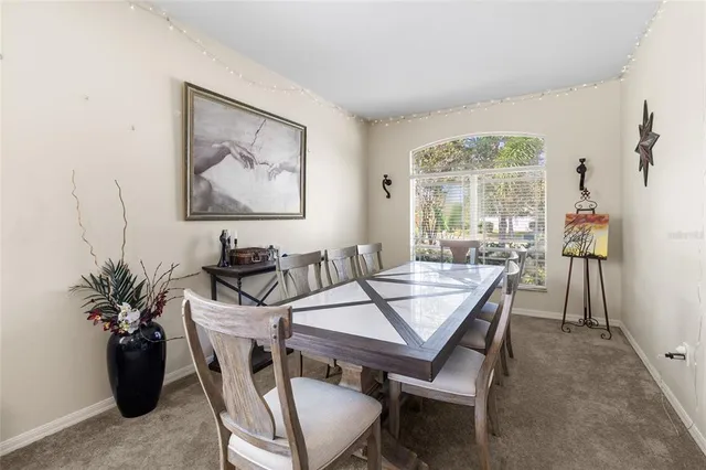 a living room with furniture a window and a painting on the wall