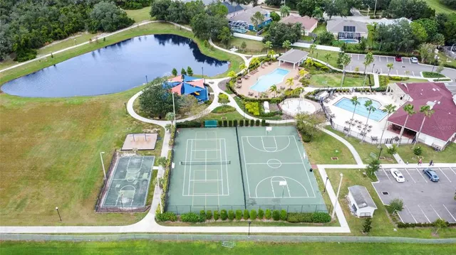 an aerial view of residential houses with outdoor space and lake view
