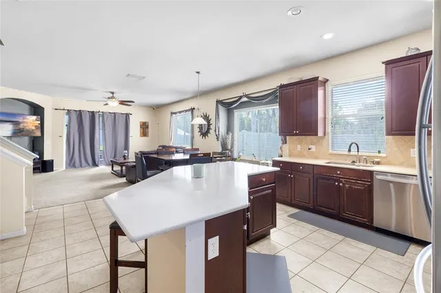 a large kitchen with kitchen island granite countertop a sink and cabinets