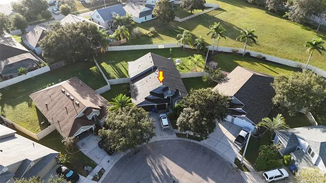 an aerial view of a house a yard and outdoor seating