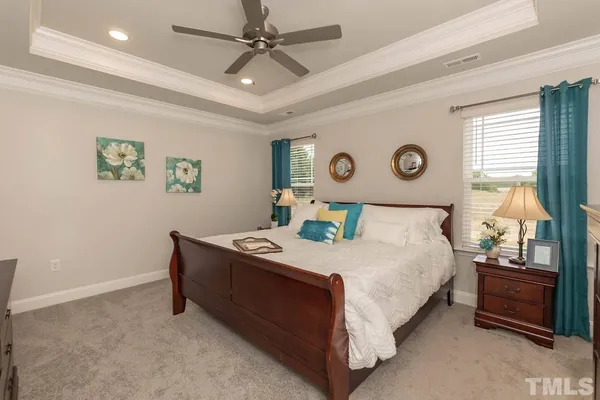 a bedroom with a bed and a chandelier